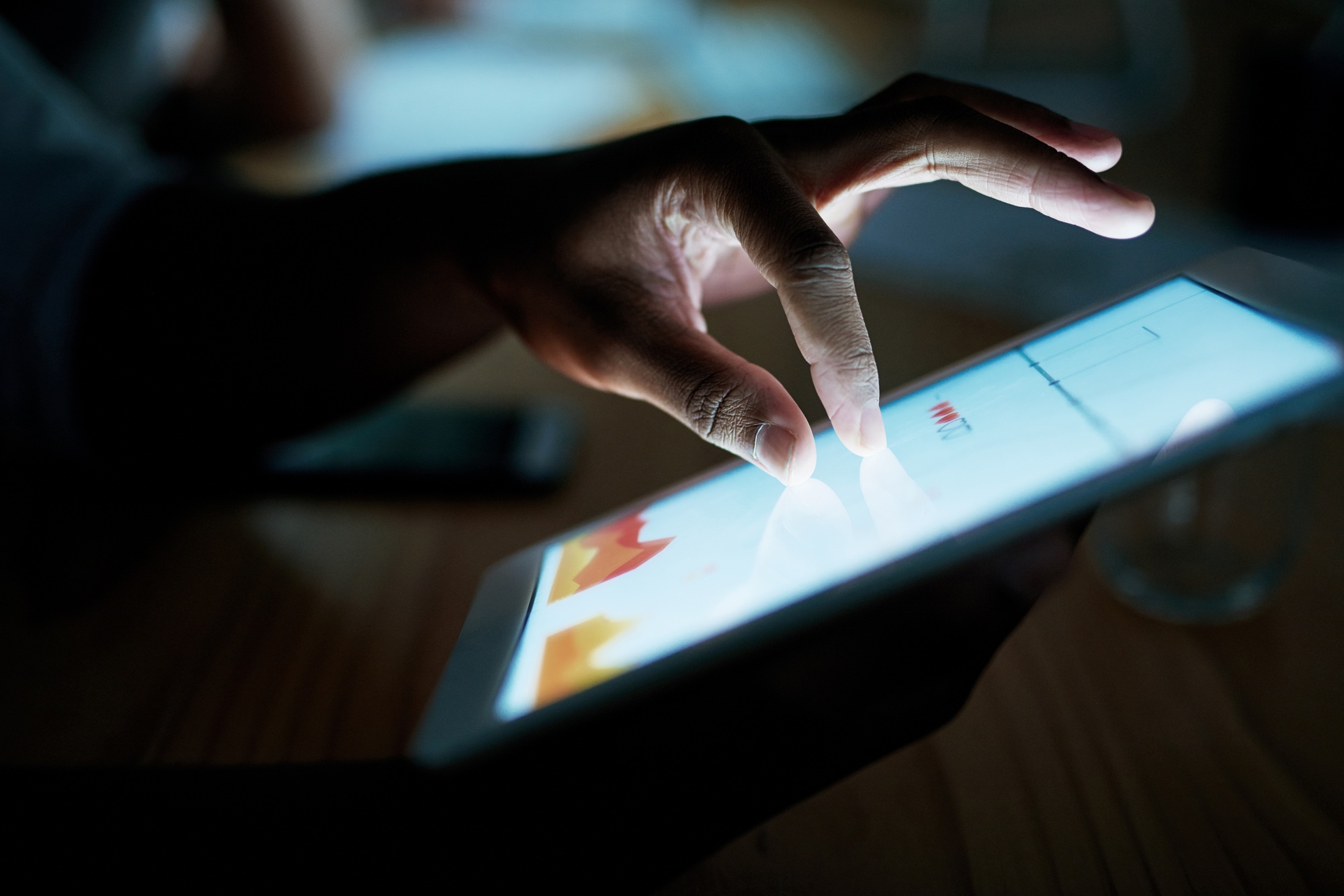 Shot of an unrecognisable businesswoman using a digital tablet during a late night at work