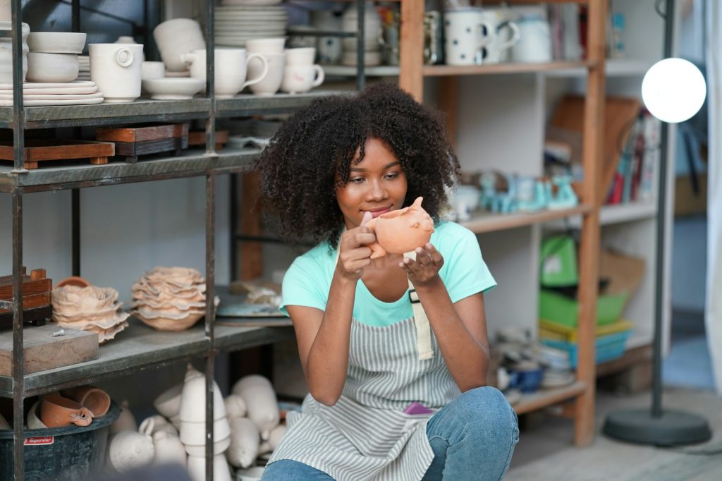 Young Woman hand potter making clay vase in pottery workshop, Business owner.